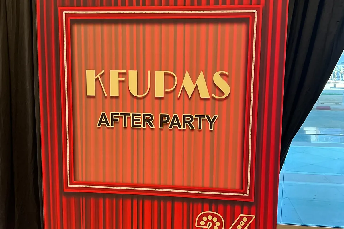 Red cinema-style after-party entrance with illuminated welcome panel