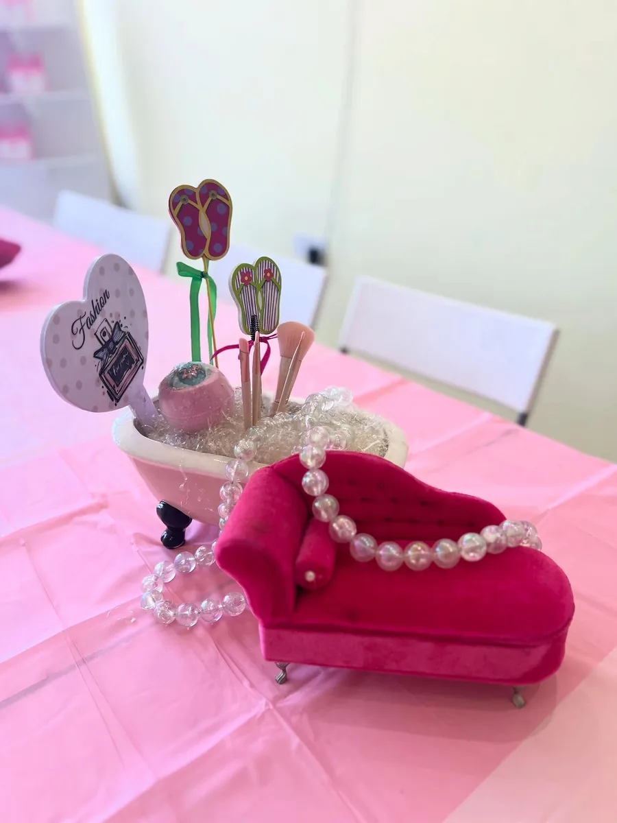 Miniature pink spa chair decorated with pearls and beauty-themed craft picks